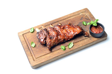 grilled ribs on a cutting board on a white background
