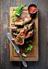 grilled ribs on a cutting board. rustic style