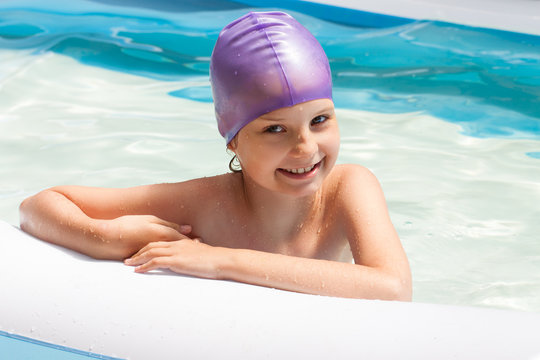 cute baby in a swimming cap. Swimming pool. Laughing baby in water