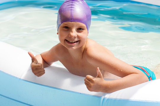cute baby in a swimming cap. Swimming pool. Laughing baby in water