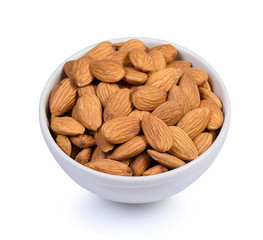 Dried almond in white bowl on white background.