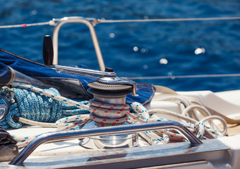 Obraz premium Coil of rope tied in a knot on a bollard. Coiled rope on boats deck