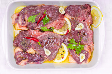 Steaks of red meat , marinated with emulsion of lemon juice and