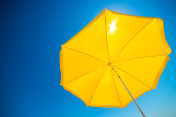 yellow umbrella on blue sky