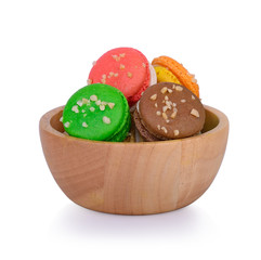 macaroons in wooden bowl on white background