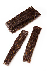 Biltong South african dried beef jerky isolated on a white studio background.