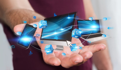 Businessman holding tech devices in his hand