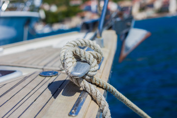 Marine knot detail on stainless steel boat railing banister. Sailboat details