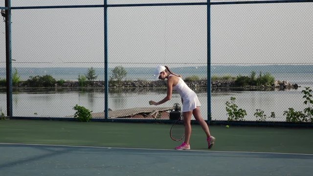 Powerful forehand. Girl playing tennis. Slow motion