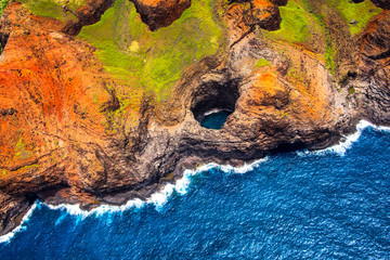 Aerial view of Na Pali coastline open ceiling cave from helicopt