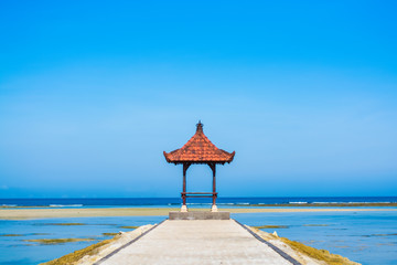 Shady pagola overlooking beautiful tropical beach