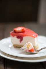 Homebaked Summer Berry Cheesecake with Jelly on the Top made from Raspberries and Strawberries on White Plates