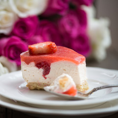 Homebaked Summer Berry Cheesecake with Jelly on the Top made from Raspberries and Strawberries on White Plates
