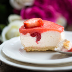 Homebaked Summer Berry Cheesecake with Jelly on the Top made from Raspberries and Strawberries on White Plates