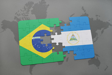 puzzle with the national flag of brazil and nicaragua on a world map background.