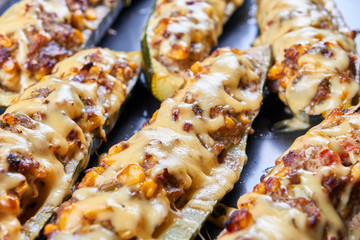 Grilled courgettes stuffed with meat and vegetables