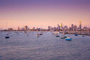 Boats at anchor in St. Kilda harbour with Melbourne skyline behind