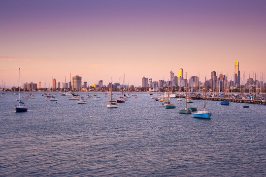 Boats at anchor in St. Kilda harbour with Melbourne skyline behind