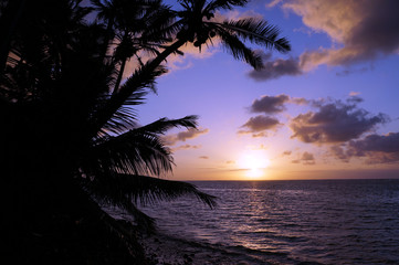 Naklejka na ściany i meble Beautiful Sunrise over the ocean with waves moving to rocky Beac