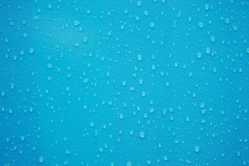 Naklejka na ściany i meble rain drop on blue plastic surface