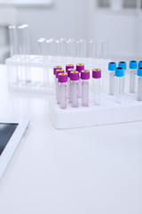 Research laboratory working space. Test tubes and tablet PC are lying at the table. Medical equipment. Blood test