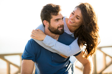 Fototapeta premium Attractive American couple embrace playful at the park