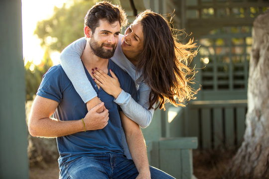 Beautiful engaged couple fiance hug and kiss good mood outside