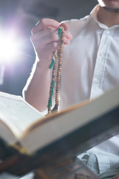 hand holding a muslim rosary