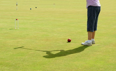Shadow of croquet player at a club in Sidmouth, Devon