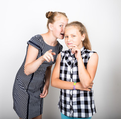 Two cute little girlfriend expressing different emotions. Funny kids. Best friends pamper and posing