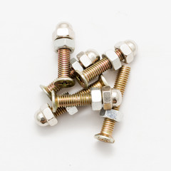 Closeup of a pile of screws screwed to their nuts isolated on white background