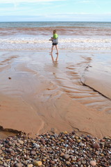 Beach during low tide in Sidmouth, Devon is part of Jurassic Coast which was awarded World Heritage...