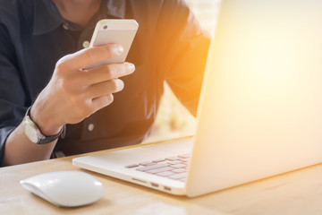 business man using smart phone and write on notebook and laptop