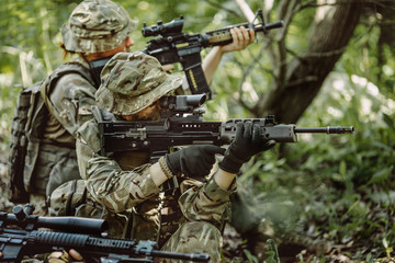 Fototapeta premium Special forces soldiers with weapon take part in military maneuv