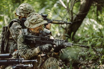 Fototapeta premium Special forces soldiers with weapon take part in military maneuv