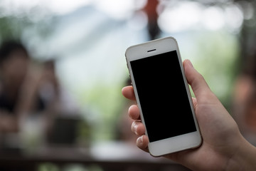 Close up of a woman using smart phone with blank mobile and cup