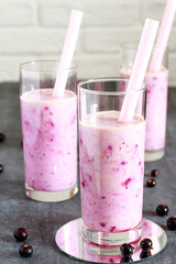 Healthy smoothie made from European black currant in a tall glass. Selective focus