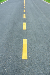 asphalt texture with yellow dashed line.