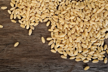 raw pearl barley on wooden background