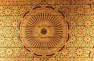 Golden eastern pattern on the ceiling of an old building in Marrakech, Morocco