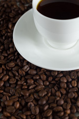 cup of coffee on coffee beans