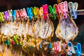 Row of dried squid, traditional squids drying in a market.