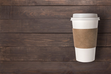 Top view coffee cup on the wooden background. Copyspace for your