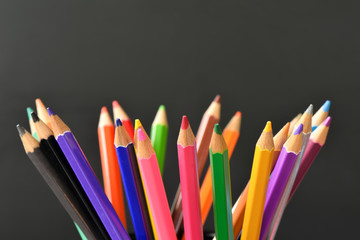 Various Colored Drawing Pencils on black background and Selective focus 