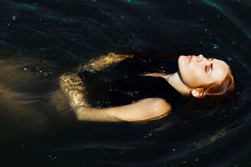 Obraz na płótnie Canvas girl swims in the sea, recreation