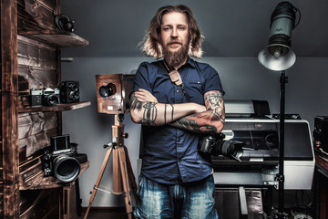 Beautiful portrait of the photographer at the workplace. The concept of the creative process, skill and favorite pastime