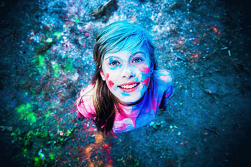 The girl in the colors of Holi smiling