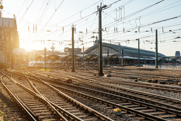 Obraz na płótnie Canvas Train railroad tracks at Europe major train station at sunrise.