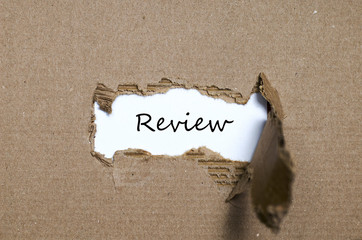 The word review appearing behind torn paper