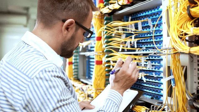 Engineer working in data room. Slow motion.